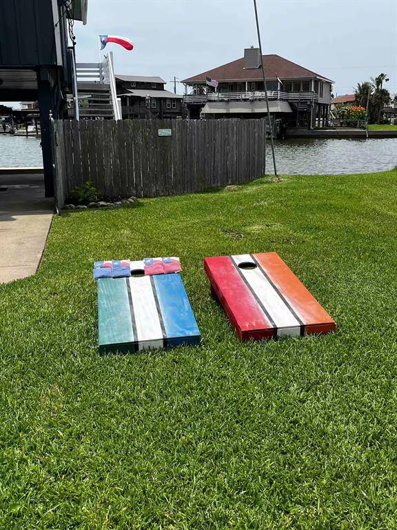 Spacious backyard with lush green grass, perfect for outdoor activities. The yard is adjacent to a waterway, providing a serene and picturesque view. Ideal for relaxation and recreation.