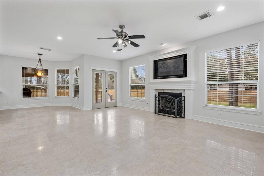 An opposite view of your wall of natural lighting, backdoors to covered porch and pool and your spacious back yard.