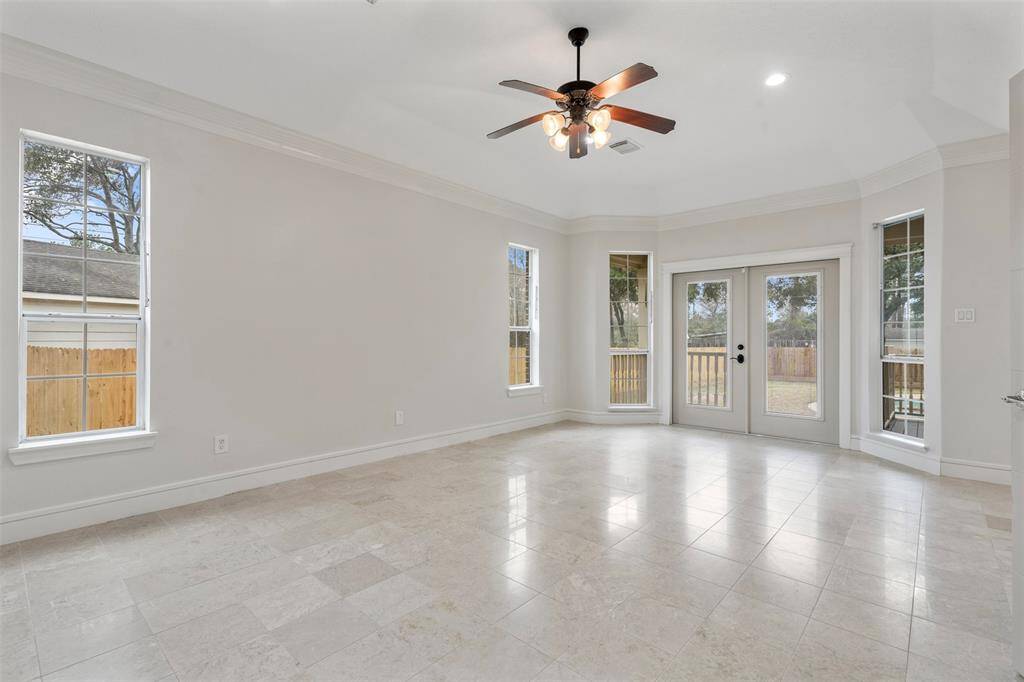Here is your principal bedroom with plenty of space here.  A view of the private access doors to the back yard and exit to the pool.