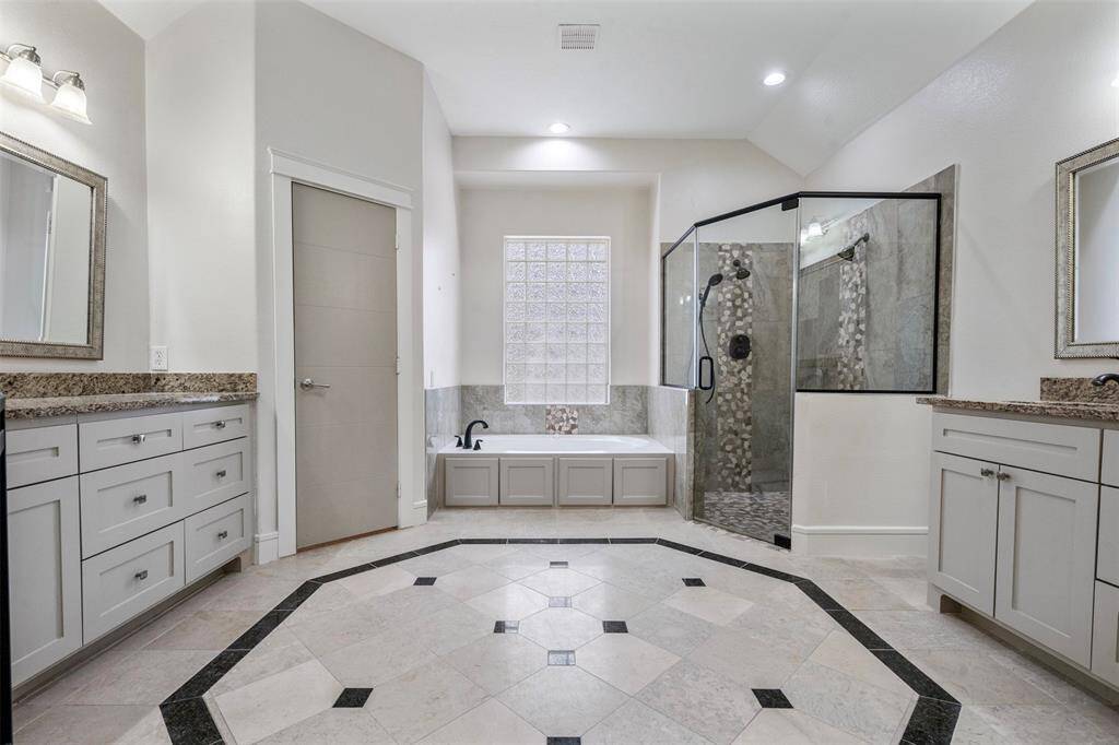 Come into the priincipal ensuite where double sinks await, jetted tub, and stand-in shower.
