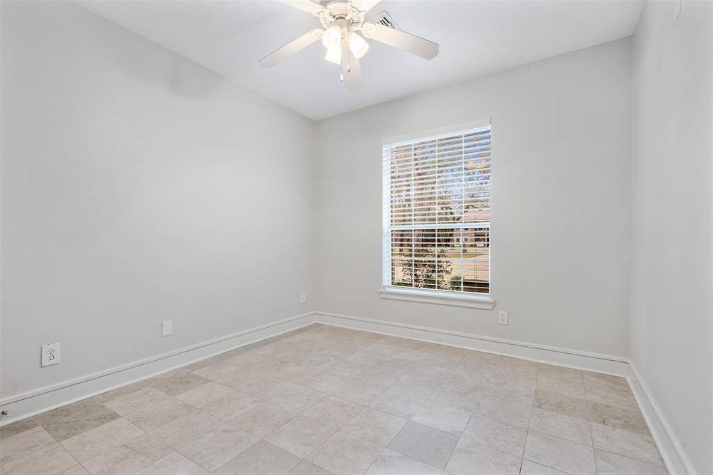 Secondary room near owner's retreat, with marble floor and a window for natural lighting.