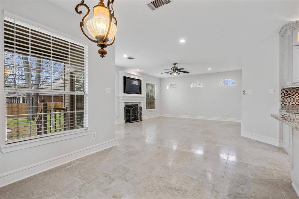 A look from the breakfast area nook to the cozy living den and fireplace.  Plenty of natural lighting here.