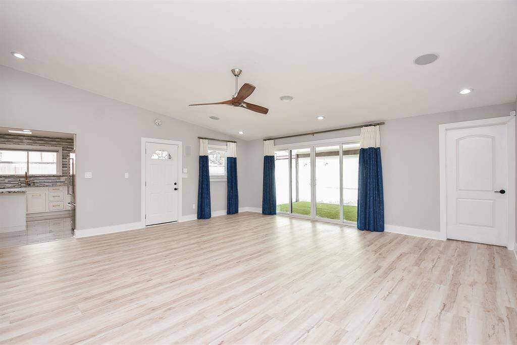 Spacious living room with sliding doors leading to a covered patio, perfect for indoor-outdoor living.