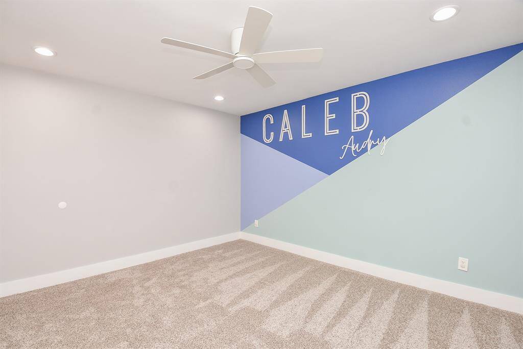 Modern and inviting secondary bedroom with ample space and stylish accents.