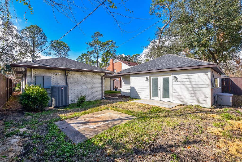 Spacious backyard featuring an attached garage and a whole-home generator for convenience and peace of mind.