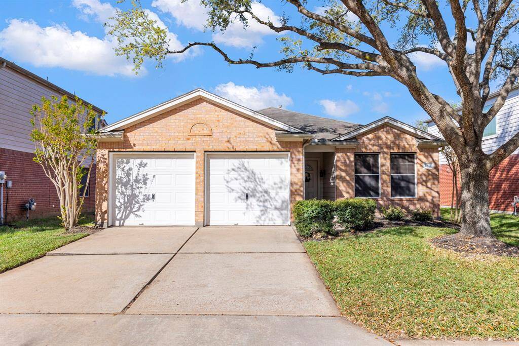 Charming three-bedroom, two-bath home with a spacious driveway and inviting curb appeal.