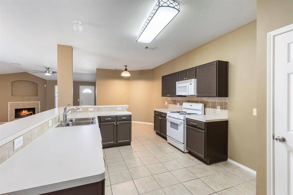 Stylish kitchen featuring sleek tile flooring and modern cabinetry.