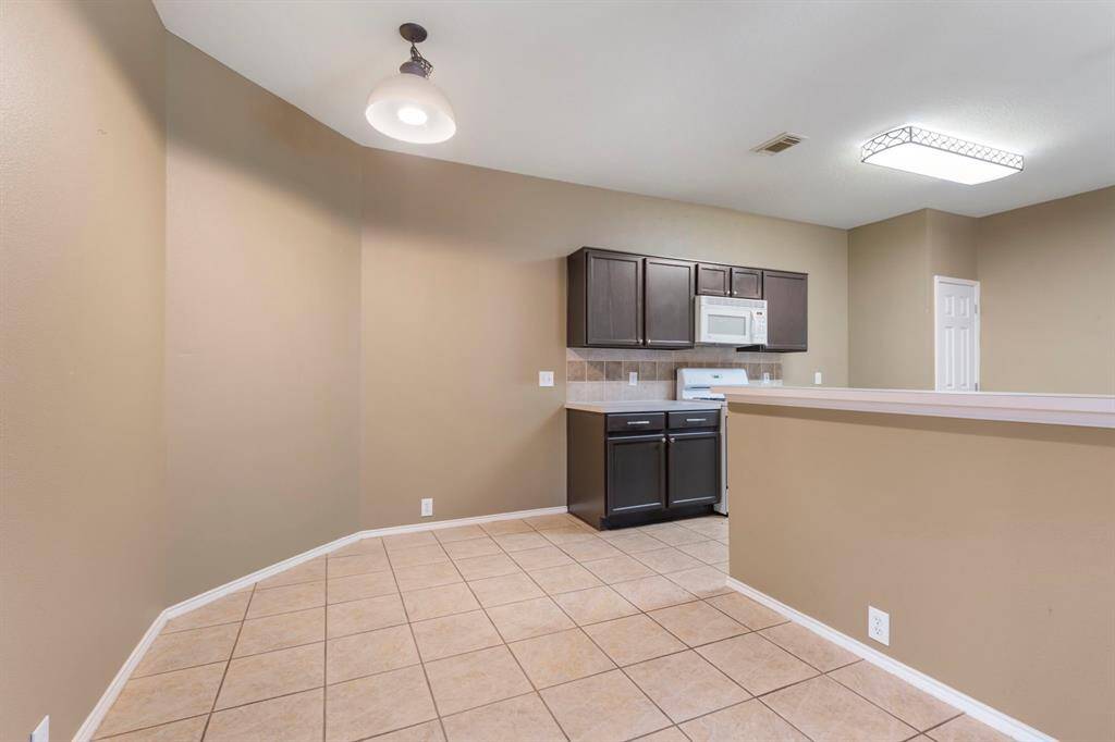 Cozy dining nook adjacent to the kitchen, perfect for intimate meals.