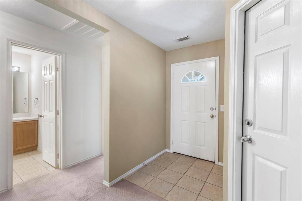 Inviting hallway leading to the second and third bedrooms.