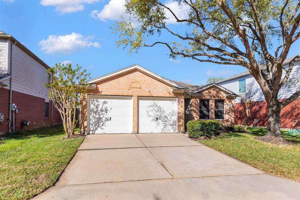 Charming single-story brick home with a double garage, nestled between mature trees. Features a well-maintained front yard and a spacious driveway. Ideal for comfortable suburban living.