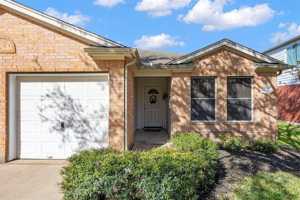 Charming single-story brick home with a welcoming front entrance, attached garage, and well-maintained landscaping. Ideal for comfortable living.