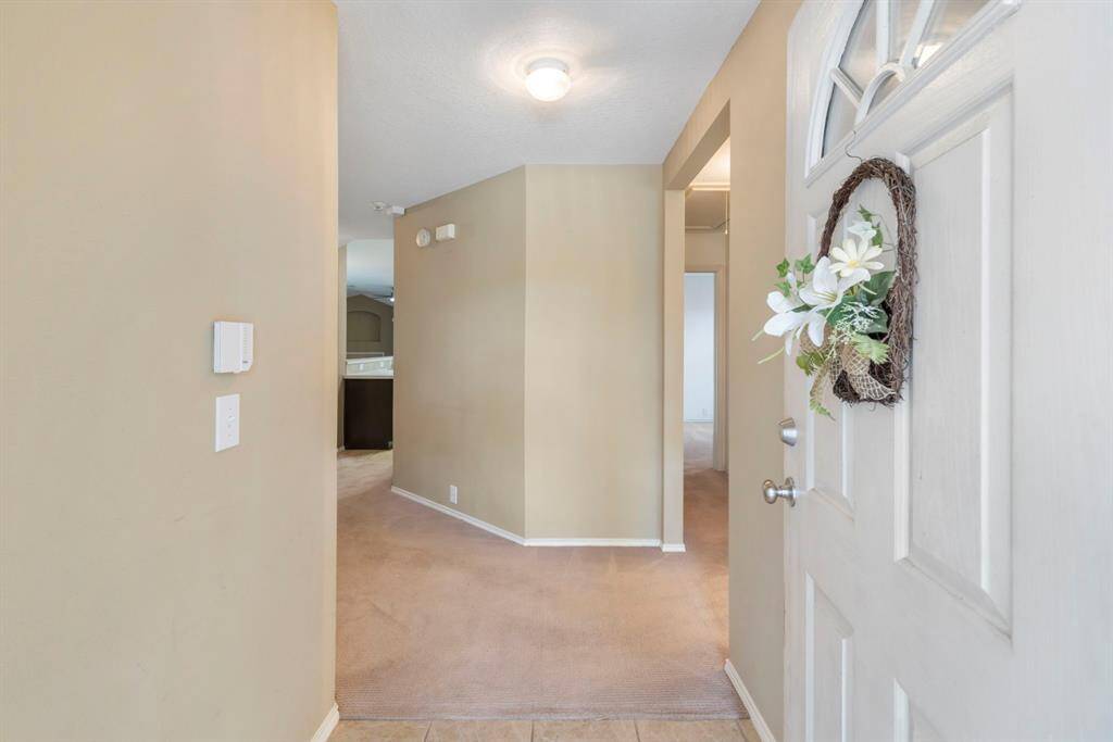 Inviting entrance with a welcoming wreath and bright interior.