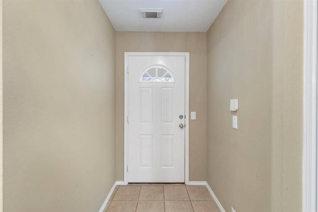 Welcoming entryway with a stylish, light-filled door.