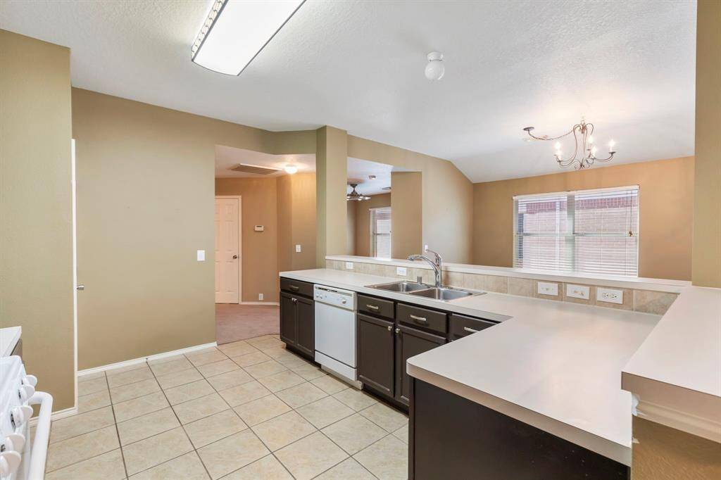 Spacious kitchen with modern fixtures, ample counter space, and abundant natural light.