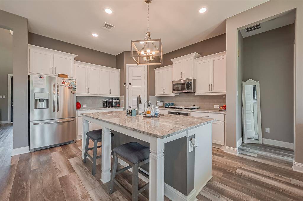 Don't miss the luxury upgrades in this kitchen! Granite countertops, custom light fixtures, and soft close cabinets and drawers elevate the space.