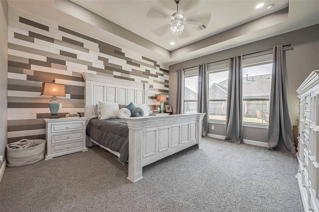 Primary room with a chandelier and shiplap feature wall.