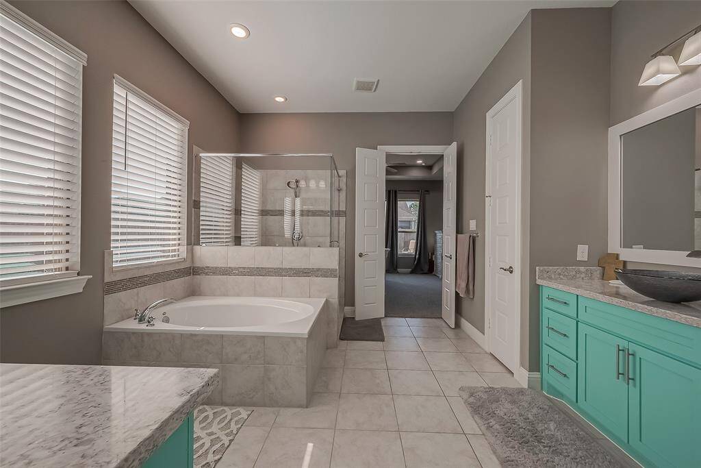 Imagine relaxing in the soaking tub or the extra large walk in shower. Linen closet on the right.