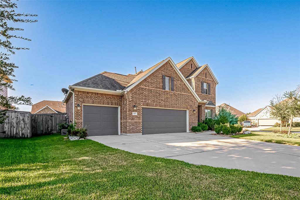 Plenty of parking in this extra wide driveway + added storage in the 3 bay garage.