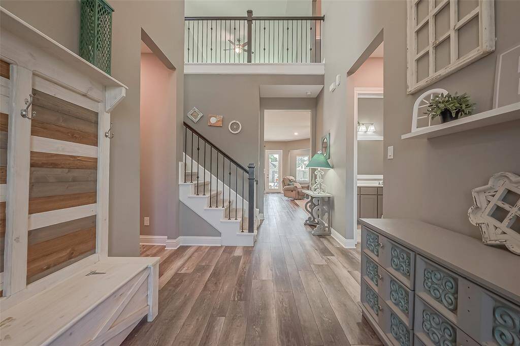 Soaring ceilings and views to the back yard add to the "WOW" factor of this home. To the right are the first of the secondary bedrooms and a full guest bathroom.