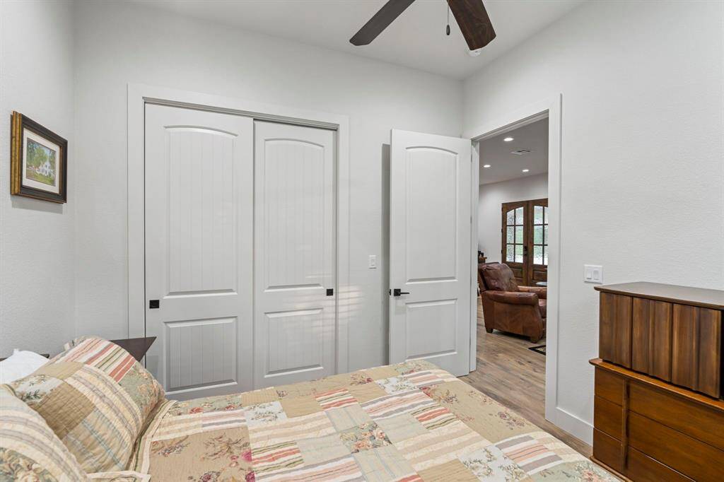 Secondary bedroom features  windows and ceiling fan.