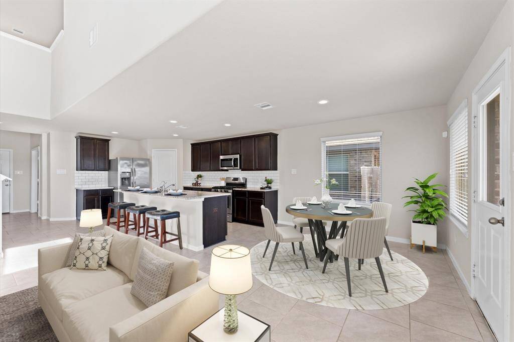The dining area is open and airy, seamlessly connecting to the kitchen for easy mealtime flow.
