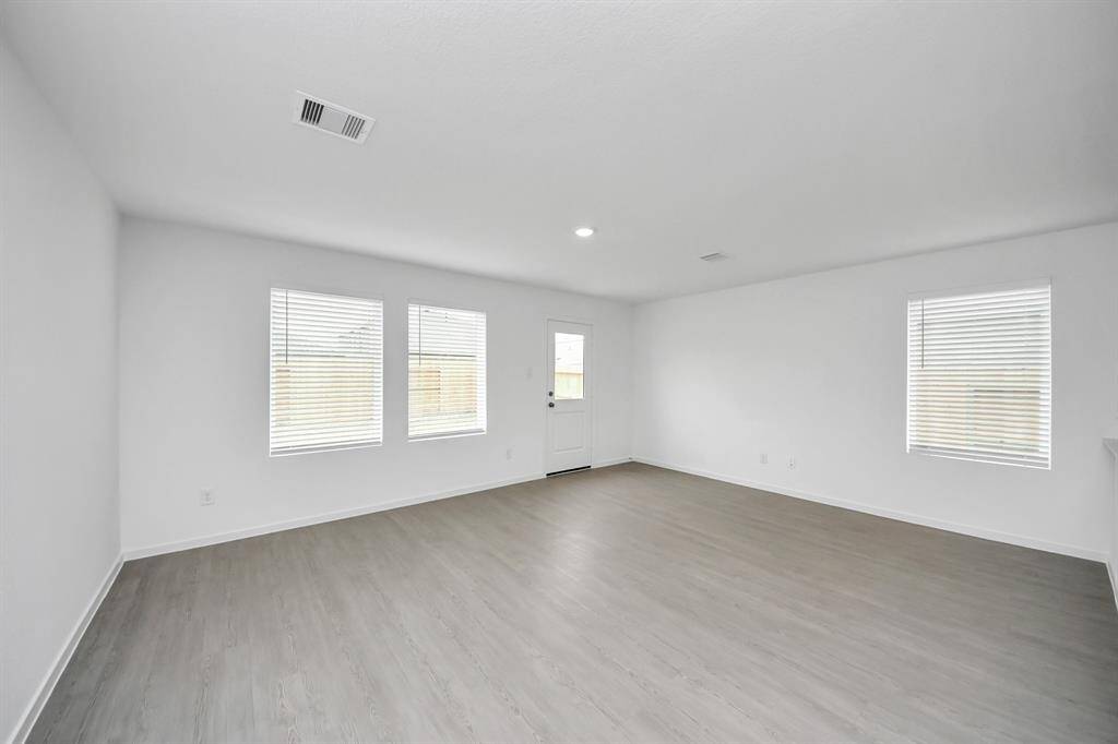 Natural light pours in through windows in the living area, enhancing the warm and welcoming atmosphere