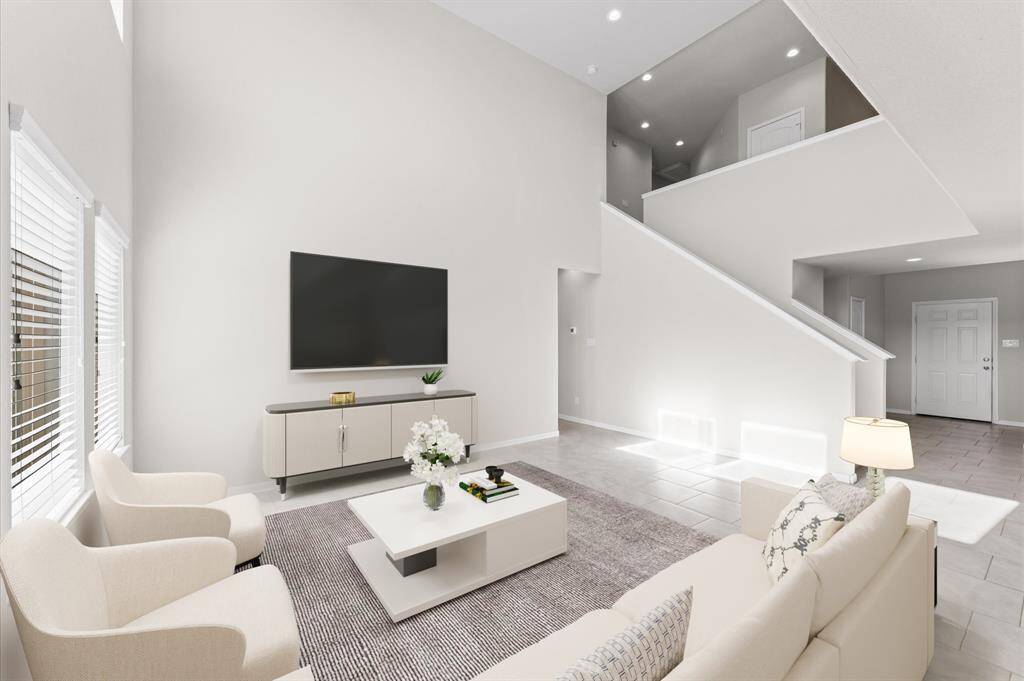 This cozy yet spacious area is perfect for relaxing with loved ones or entertaining guests. The open flow into the dining and kitchen areas makes it an ideal spot for gatherings.