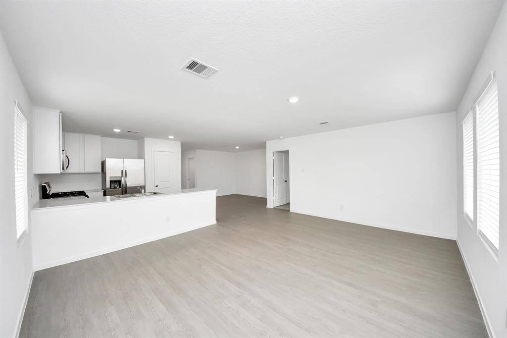 The open-concept design allows for a seamless view from the living area into the kitchen and dining space, creating an inviting and connected atmosphere.