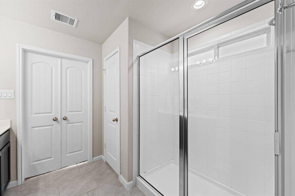 The shower room is a modern and refreshing space designed for relaxation. With sleek tile walls and a spacious layout, it provides a spa-like experience right at home.