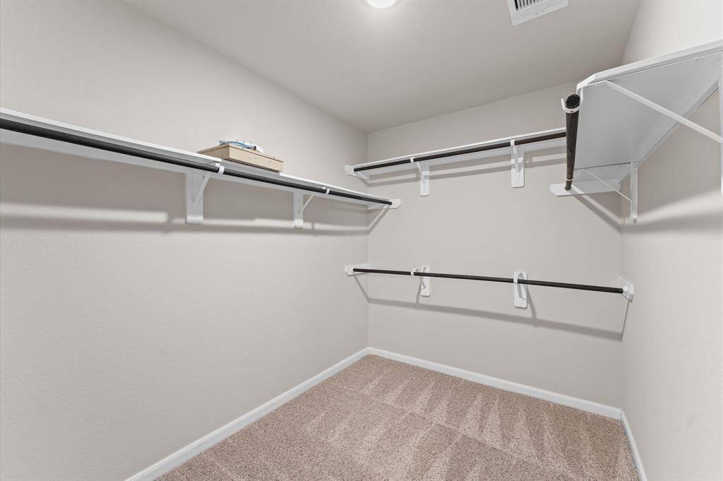 The walk-in closet is thoughtfully designed, offering generous storage to keep your wardrobe neatly organized.