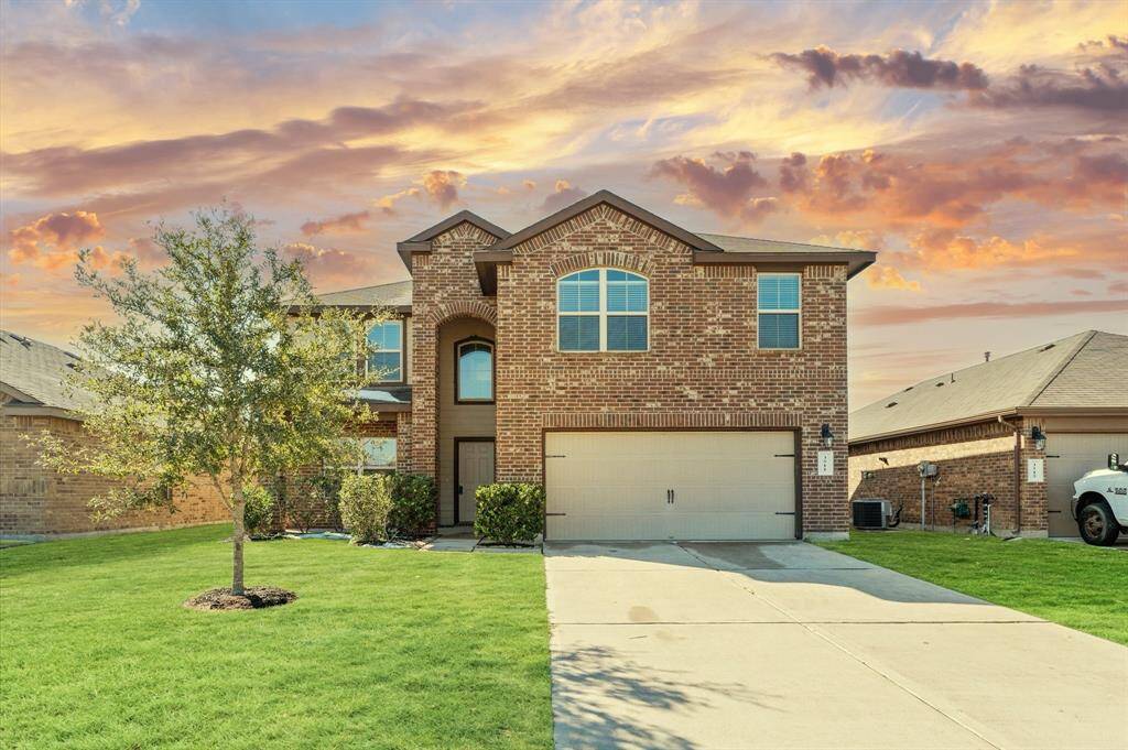 The expansive front yard welcomes you with its lush green lawn, offering plenty of space for outdoor activities or charming landscaping.