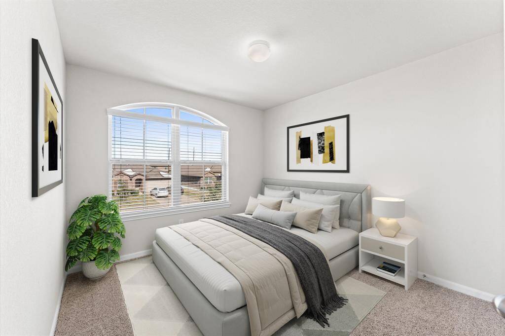 The third bedroom is spacious and comfortable, featuring a large window that lets in natural light. With its carpet flooring and warm atmosphere, it’s an ideal retreat for family or guests.
