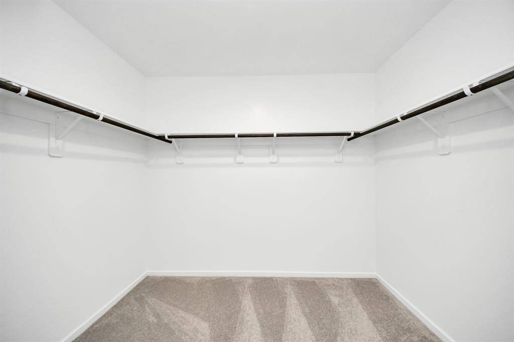 The spacious primary bedroom features a generous walk-in closet, providing ample storage and organization.