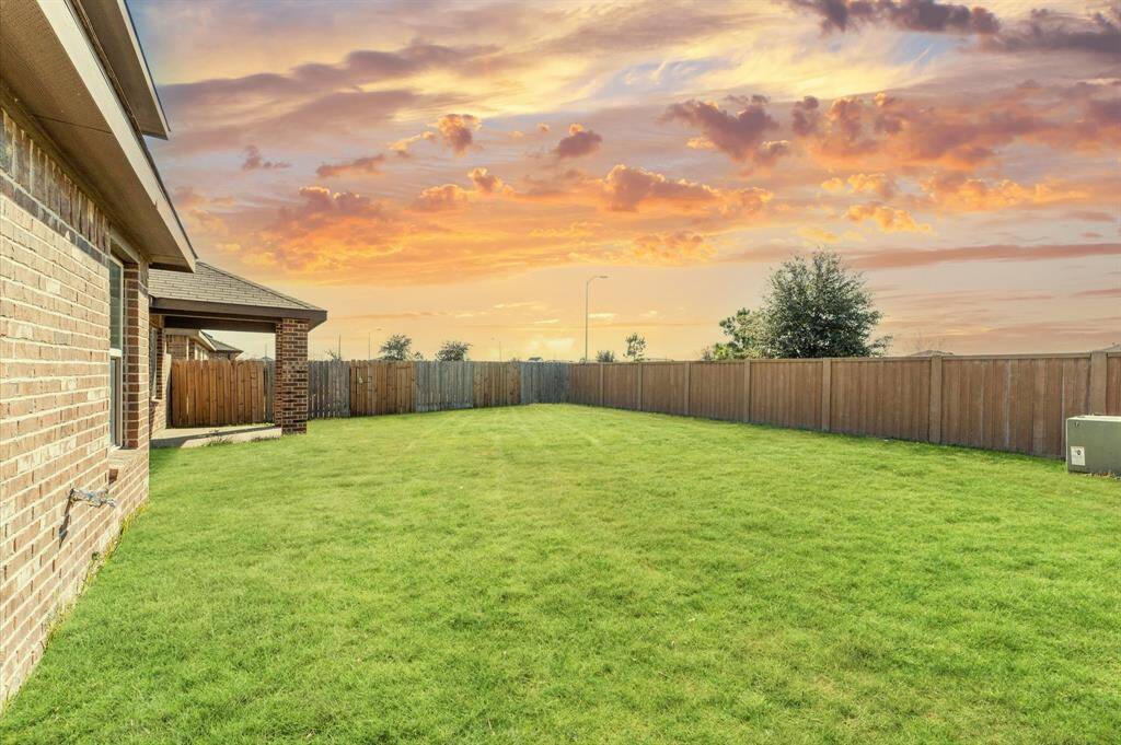 The manicured lawn provides plenty of room for kids to play, pets to roam, or for cultivating a garden. This private retreat offers endless opportunities for outdoor fun and relaxation.