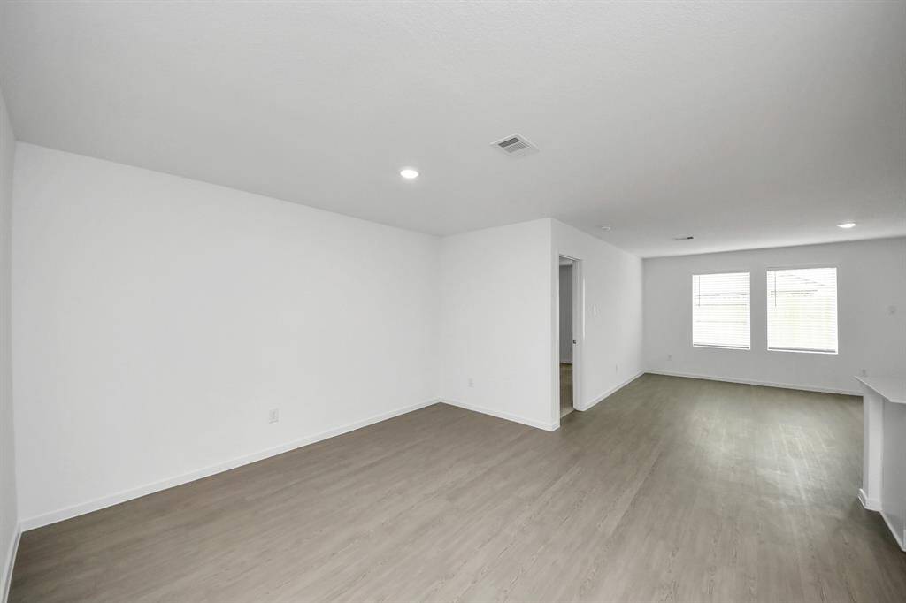 The spacious dining area offers the perfect setting for gatherings, seamlessly connecting to the open-concept kitchen and living space.