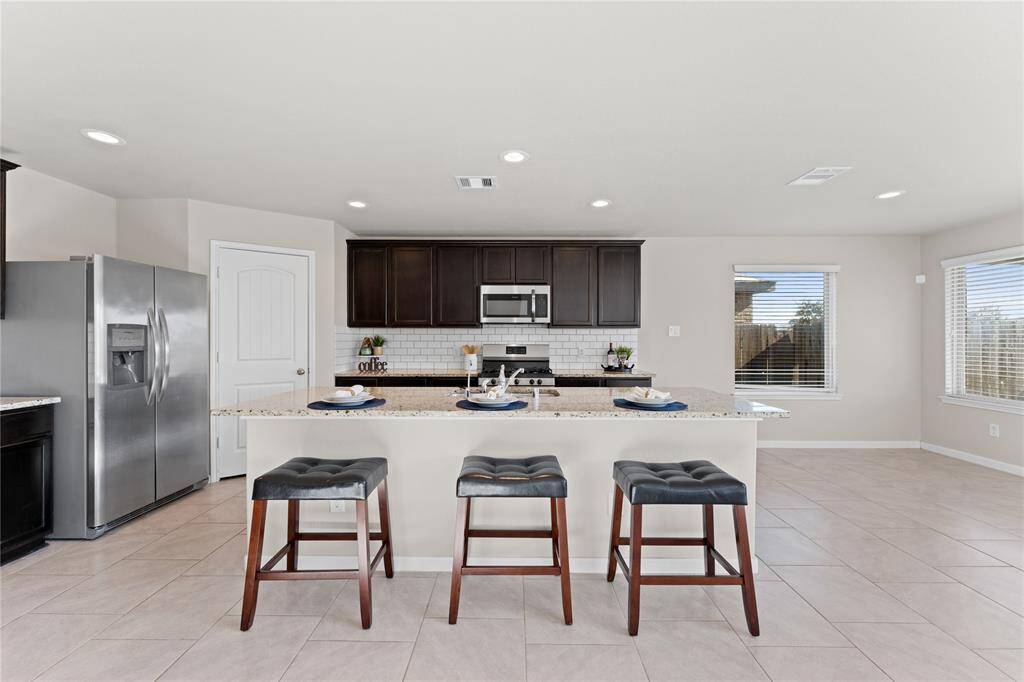 Stainless steel appliances and custom cabinets combine beauty and functionality.