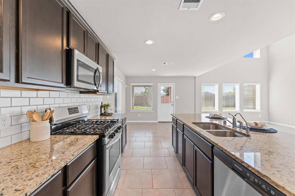 A stylish tile backsplash adds a touch of elegance, complementing the sleek design.