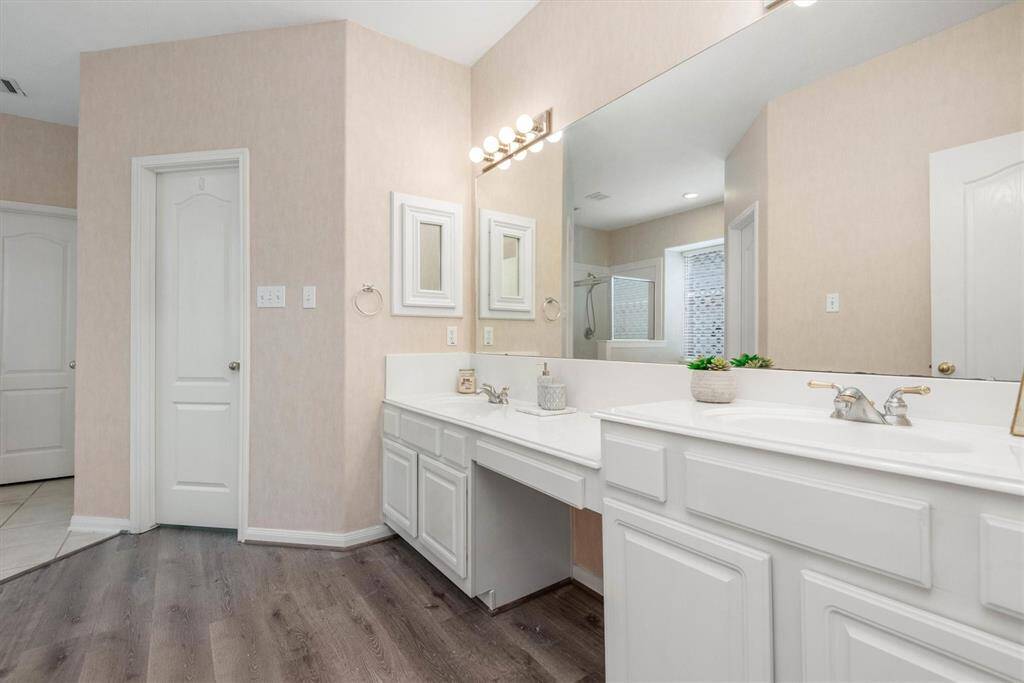 Primary bathroom features a dual sink vanity.