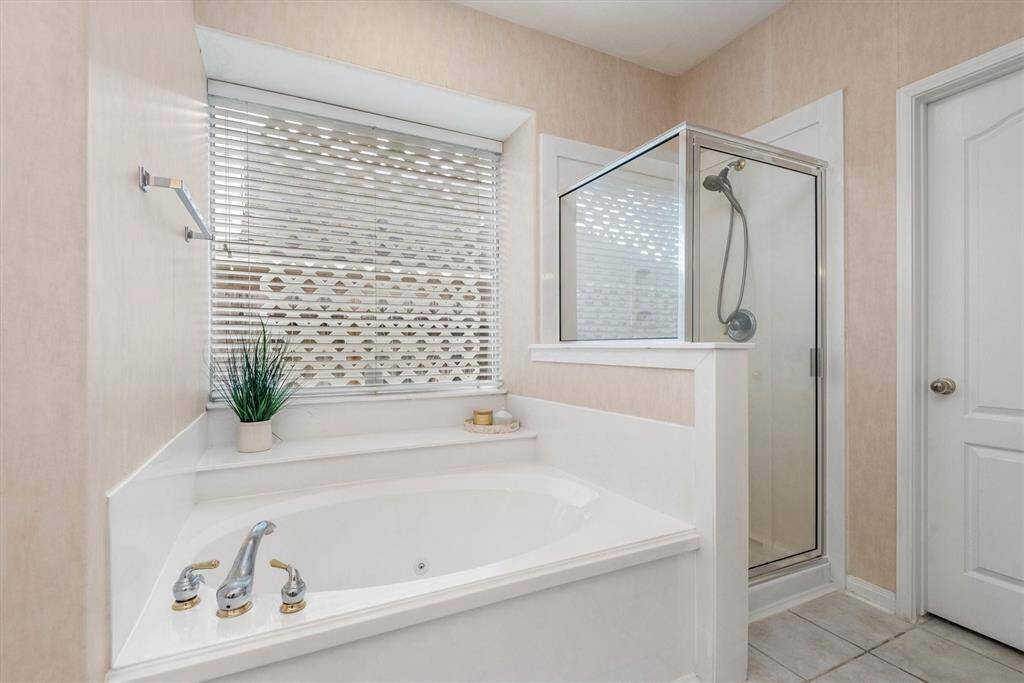 A relaxing whirlpool tub and separate shower complete the primary bathroom.