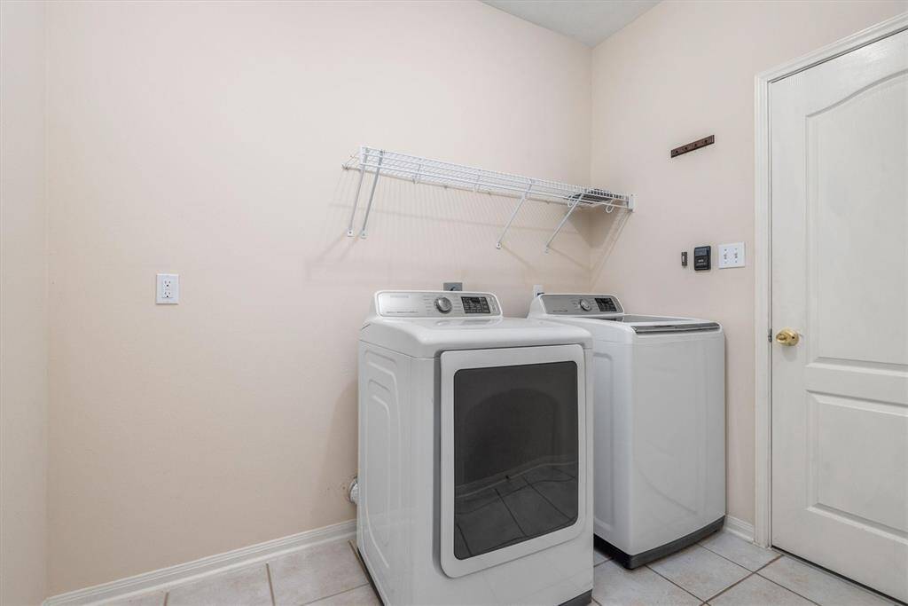Walk-in laundry room has ample of space to add shelving etc!