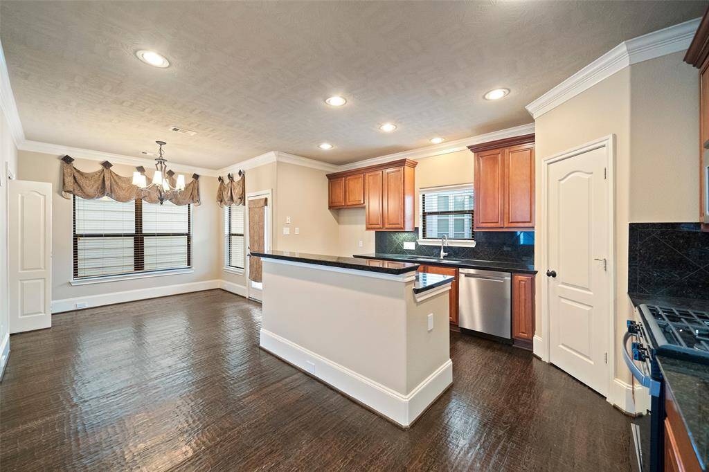 Explore the seamless flow of the modern kitchen into the inviting breakfast nook, bathed in natural light.