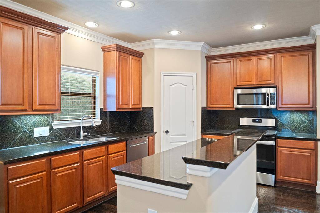Experience culinary excellence in this kitchen, featuring a state-of-the-art Whirlpool gas range with self-cleaning and speed heat capabilities, installed in December 2021.