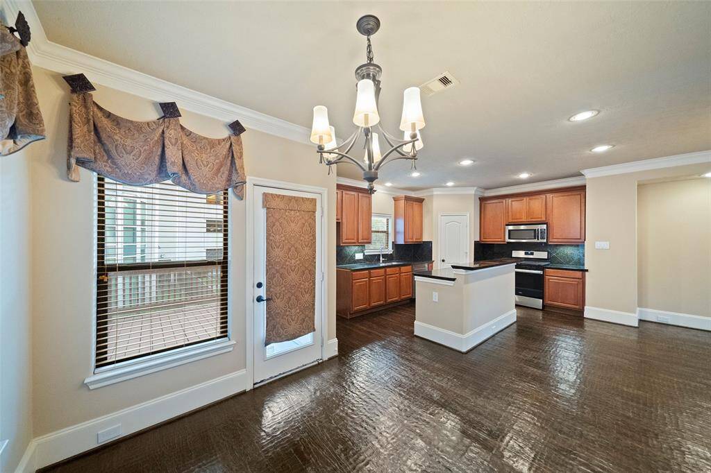 Seamless flow from the cozy breakfast nook to the inviting, well-appointed kitchen.