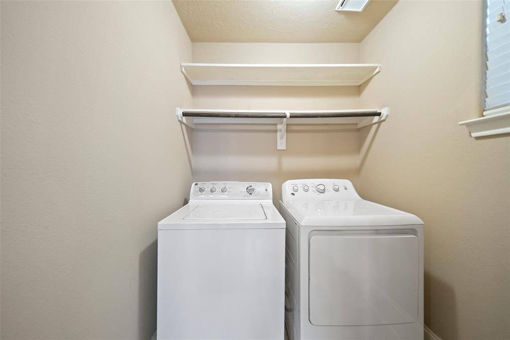 Convenient second-floor laundry space, complete with a ready-to-use washer and dryer set.