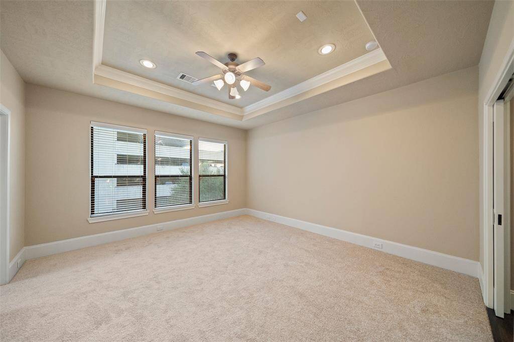 Explore the spacious elegance of the master bedroom retreat, complete with plush carpeting and abundant natural light.
