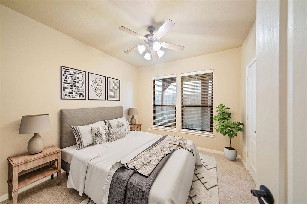 Charming first-floor bedroom with newly painted walls and plush carpeting, beautifully presented with virtual staging.