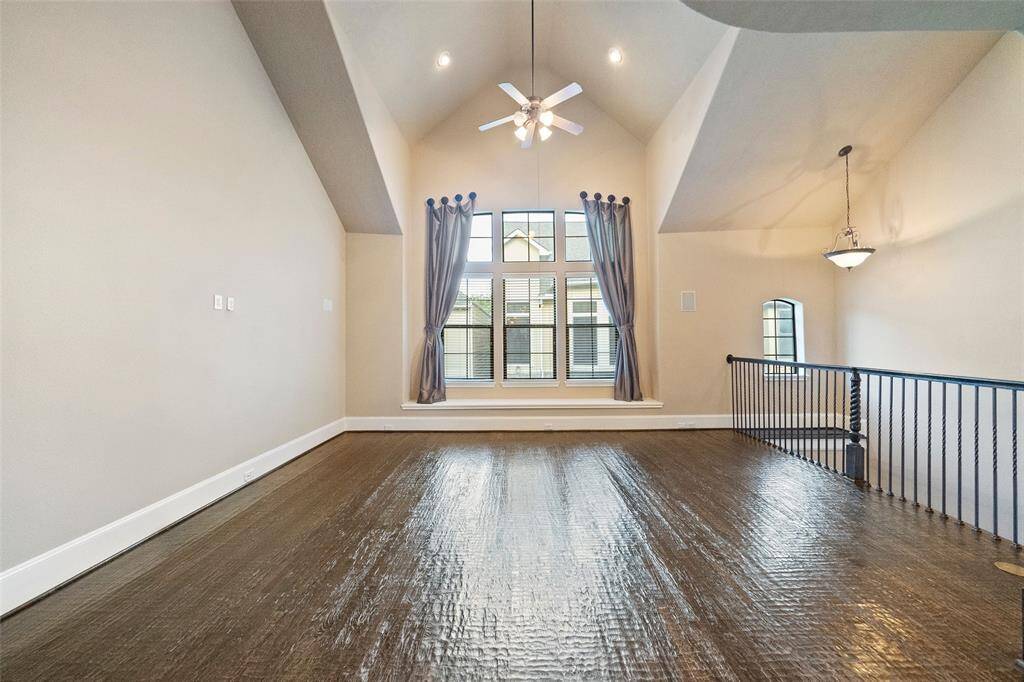 Host with style in the spacious living room, complete with high ceilings and elegant hardwood floors.