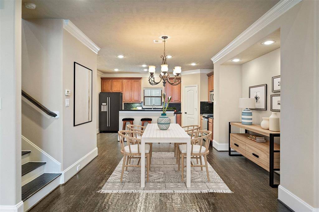 Enjoy seamless entertaining in this open-concept dining area, flowing effortlessly into the living room and kitchen. This space is virtually staged to inspire your own design.