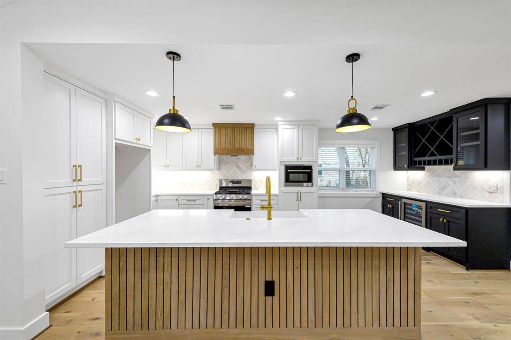 The kitchen boasts high-end finishes, custom cabinetry, and ample prep space for all your culinary needs.