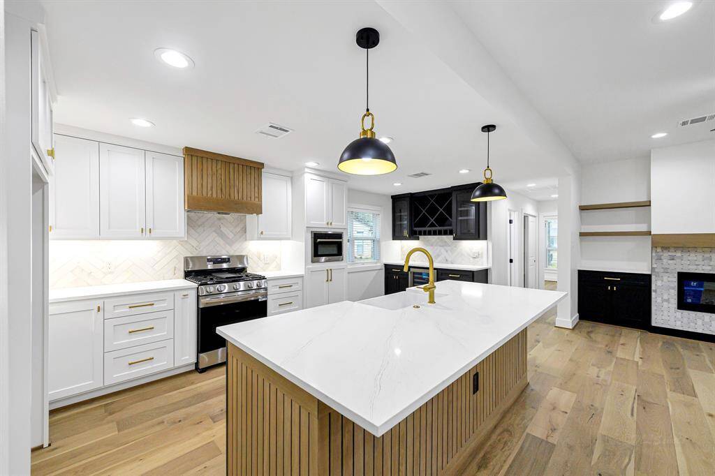 A beautifully designed kitchen featuring an oversized island, perfect for casual dining or entertaining guests.